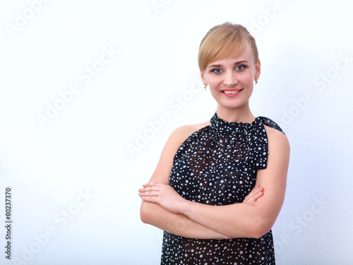 Portrait of an attractive young woman standing with crossed arms