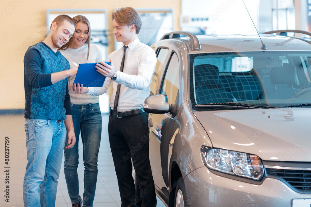 Couple talking to sales consultant in showroom Couple talking to sales consultant in showroom