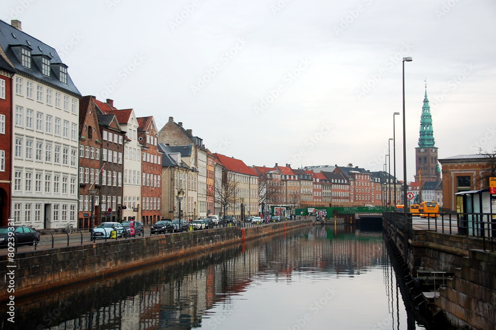 Streets of Copenhagen with its canals, boats and buildings. 