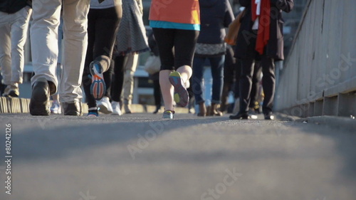 Pedestrians and joggers in slow motion in the city. Find similar