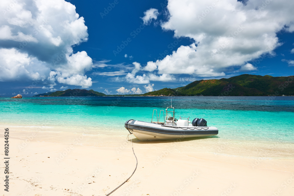 Tropical beach at Seychelles with inflatable boat