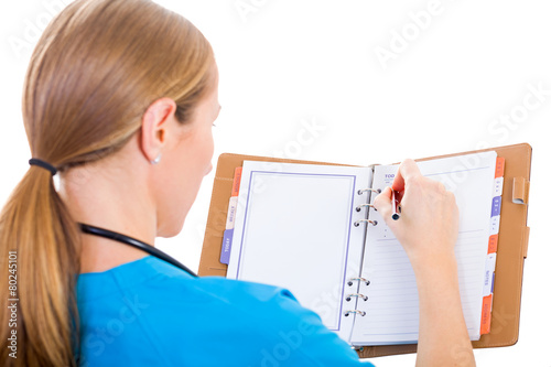 фотографія Young doctor writing report