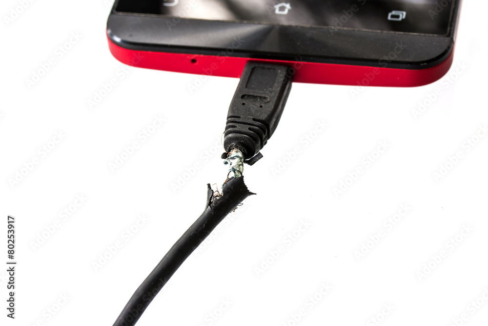 close up image of broken phone charger cable on white close up image of broken phone charger cable on white