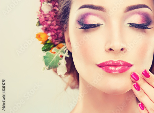 Girl with delicate  flowers in hair and fashion  fuchsia nail