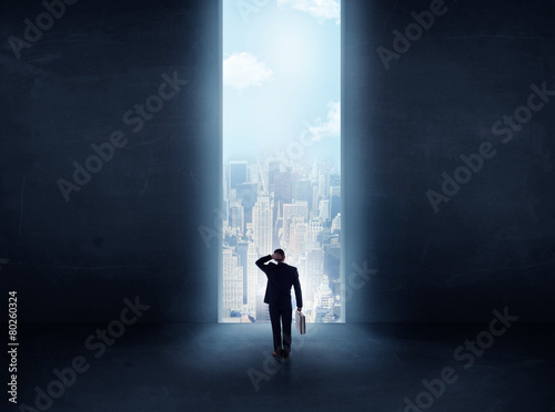 businessman in front of the huge gate