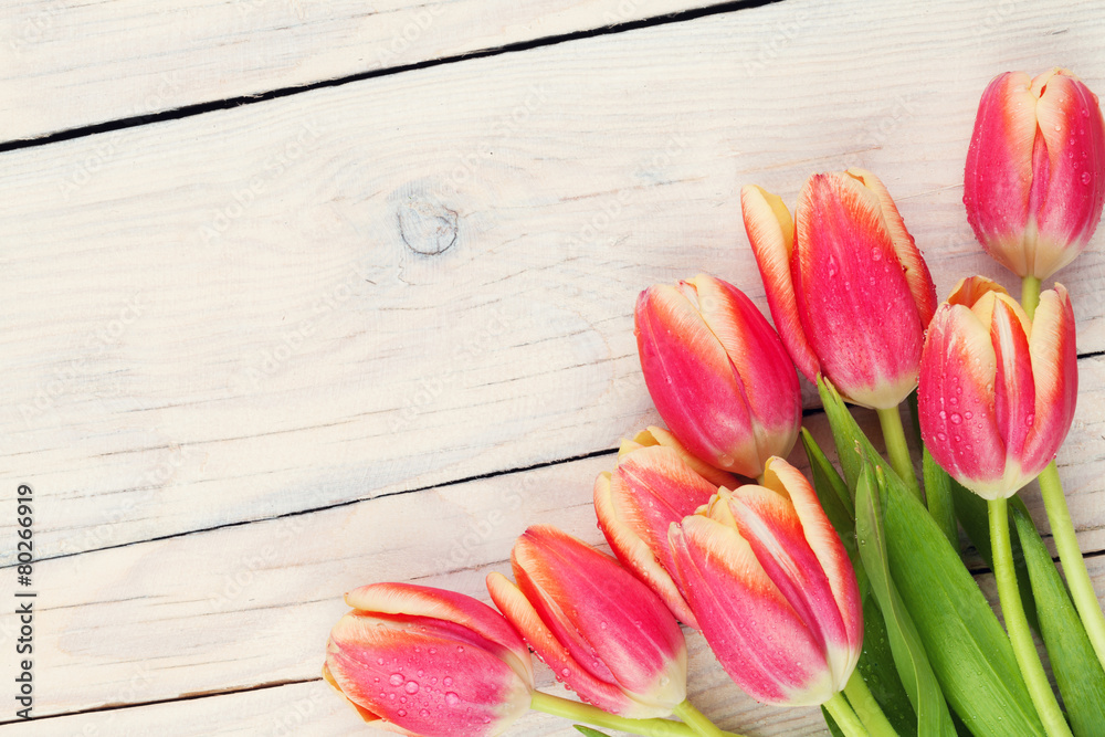 Colorful tulips on wooden table