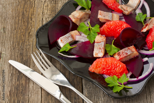dish with a salad of herring, beetroot and grapefruit photo
