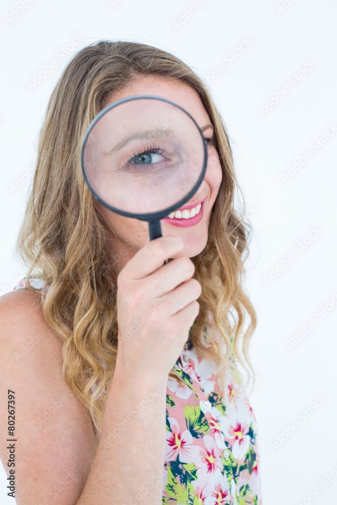 Smiling woman holding magnifying glass Smiling woman holding magnifying glass