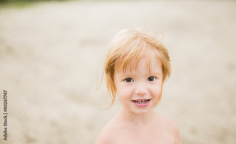 Toddler girl with red hair at the beach Toddler girl with red hair at the beach