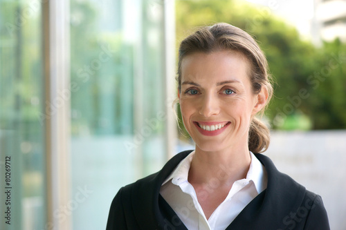 Smiling business woman with black jacket and white shirt