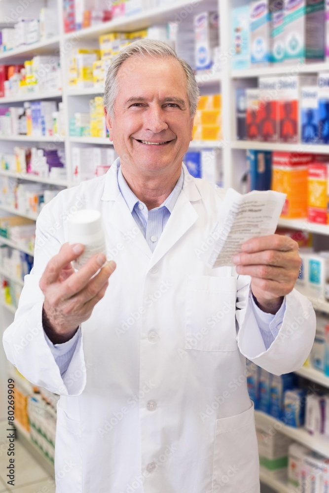 Senior holding medicine box and prescription