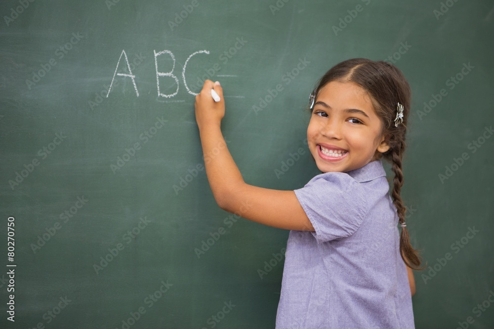 Pupil writing on large blackboard