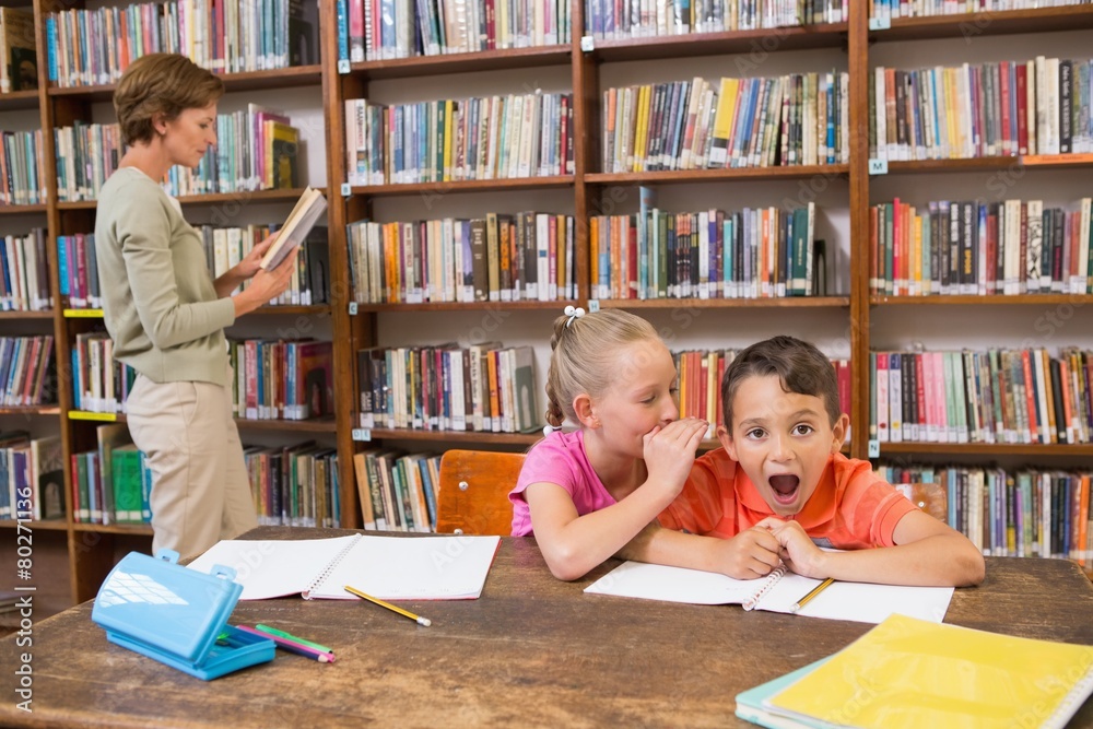 Cute pupils speaking at library Cute pupils speaking at library