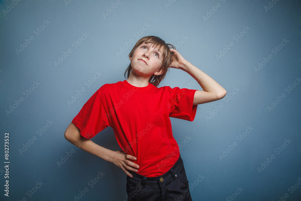 Boy, teenager, twelve years in the red shirt, thoughtful, derzhe Boy, teenager, twelve years in the red shirt, thoughtful, derzhe