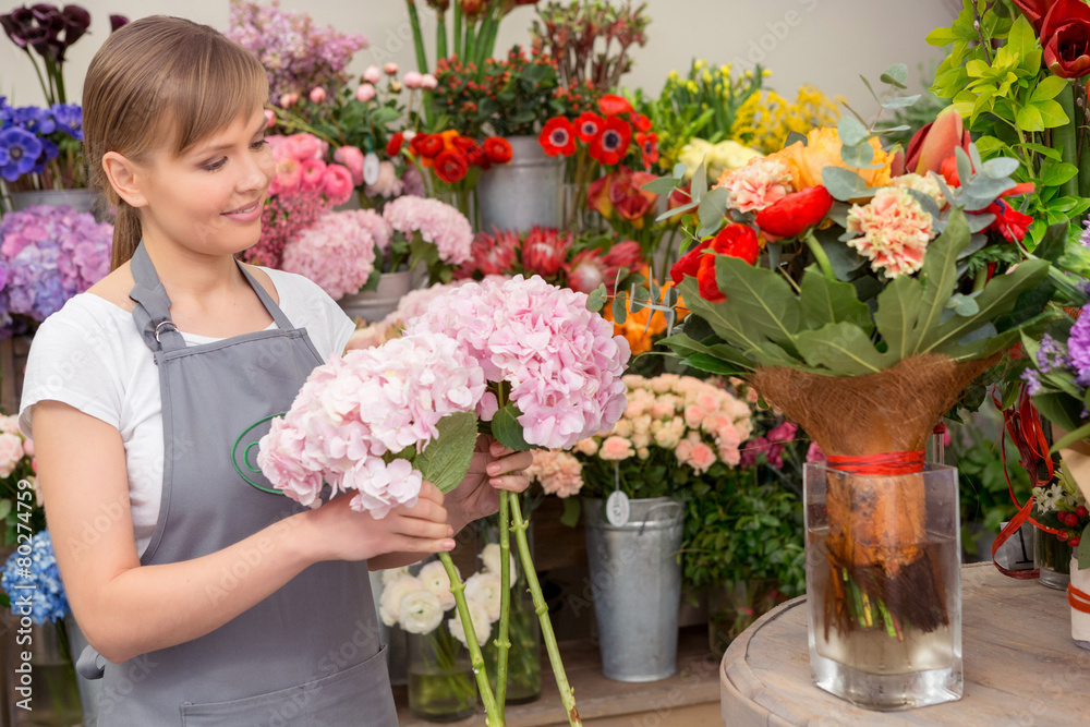 Florist puts bouquet into the vase