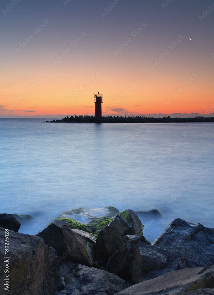 Seascape at sunset - lighthouse on the coast