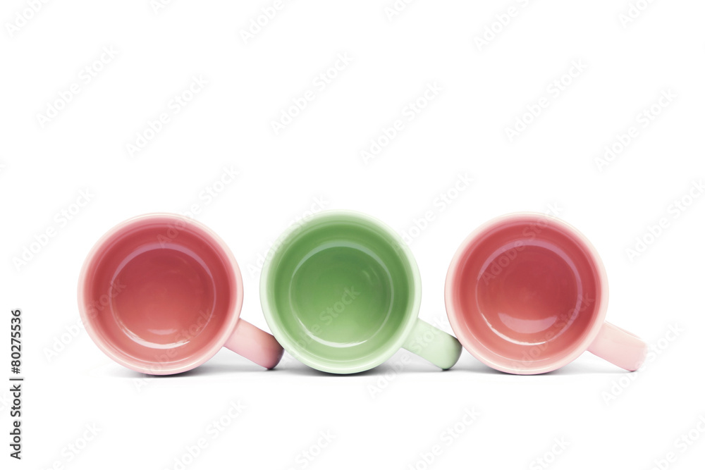 Green and pink ceramic coffee cups on white background Green and pink ceramic coffee cups on white background