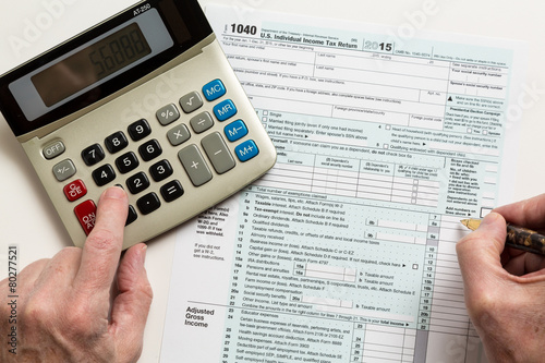 Pen and calculator on 2015 form 1040