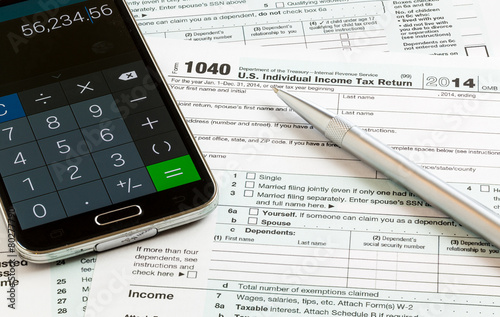 Pen and smartphone on 2014 form 1040