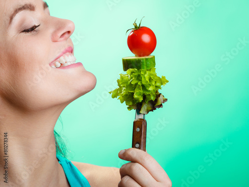 Portrait of smiling woman holding healthy food.