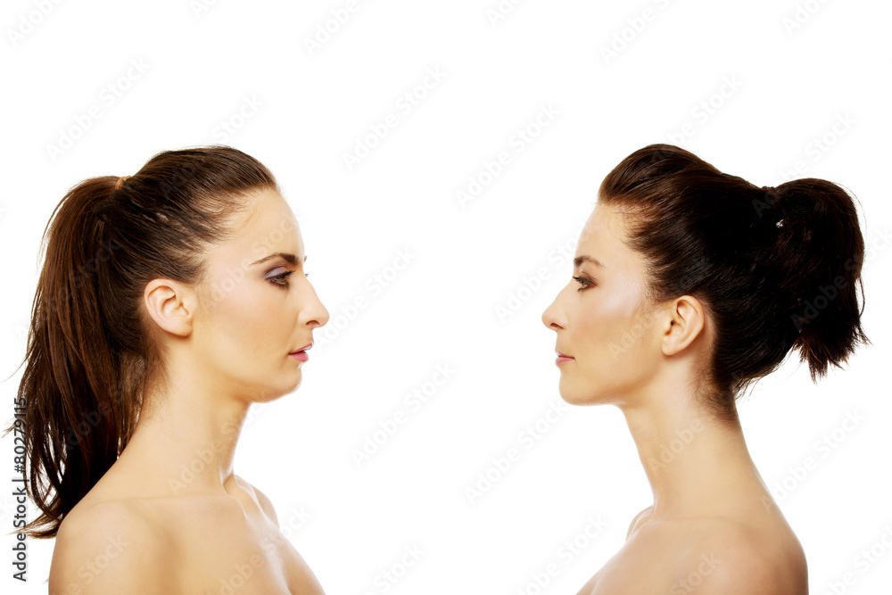 Two sisters standing face to face. Two sisters standing face to face.