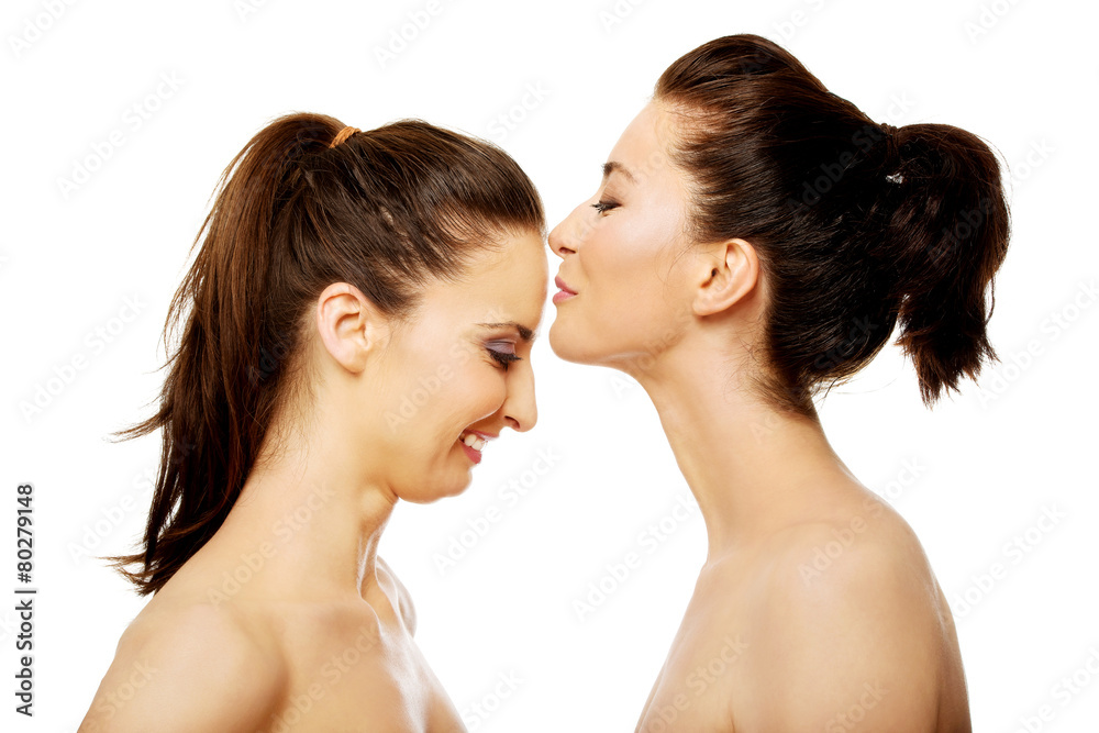 Woman kissing friend in forehead. Woman kissing friend in forehead.