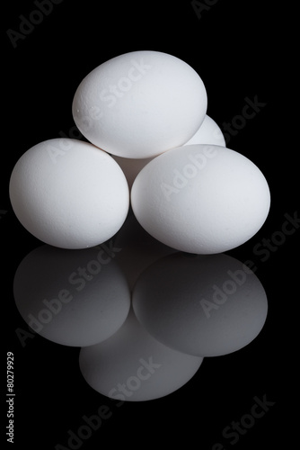 chicken eggs on a black background
