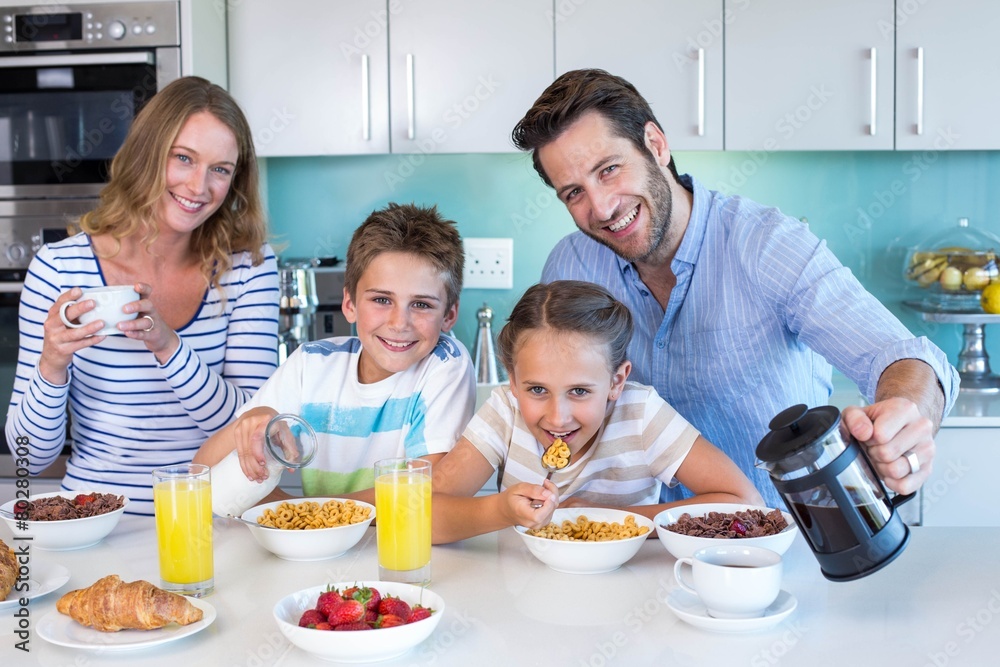 Happy family having breakfast together