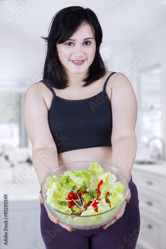 Pregnant mother holding salad