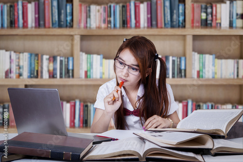 Teenage girl studying in the library