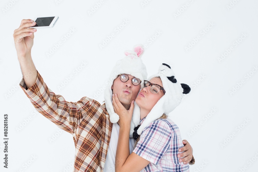 Geeky hipster couple taking selfie with smart phone Geeky hipster couple taking selfie with smart phone
