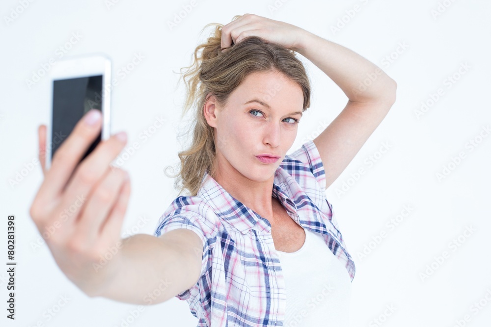 Pretty hipster taking selfie with smartphone Pretty hipster taking selfie with smartphone