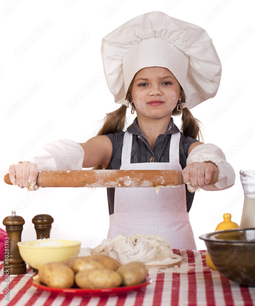 Сute little girl baking on kitchen and shows rolling-pin Сute little girl baking on kitchen and shows rolling-pin