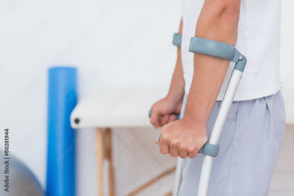 Patient standing with crutch - obrazy, fototapety, plakaty 
