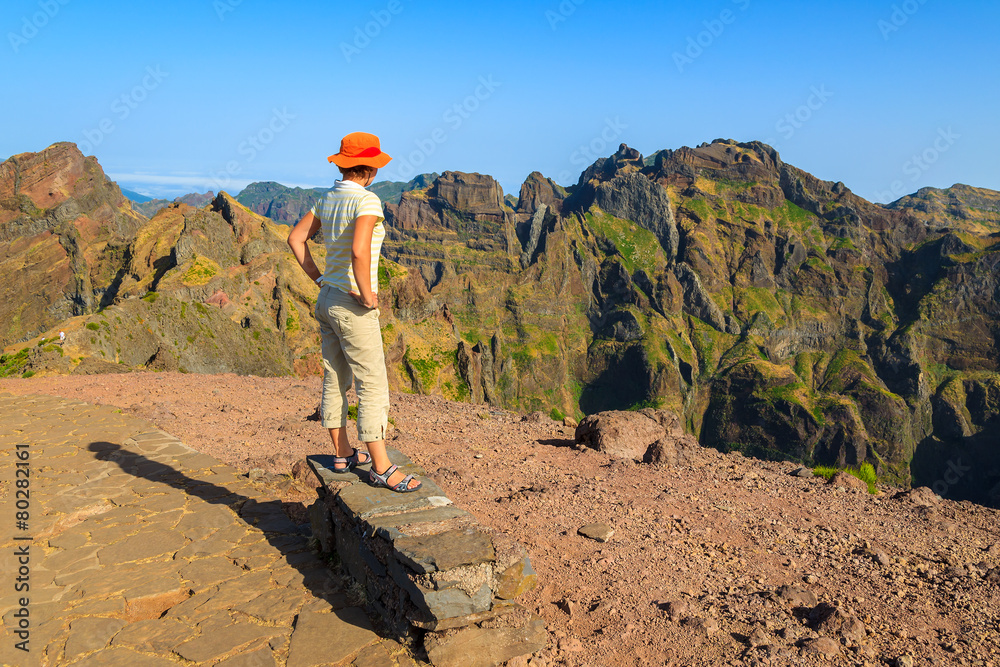 Fototapeta premium Woman tourist on mountain path, Madeira island, Portugal
