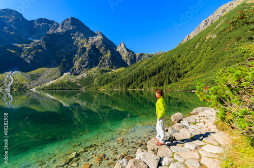 Woman tourist at Morskie Oko lake in summer, Tatra Mountains