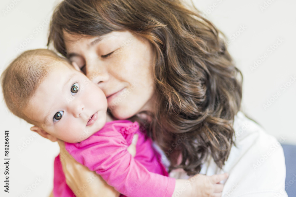 Family Concept: Portrait of Young Mother Taking Care of Her Litt Family Concept: Portrait of Young Mother Taking Care of Her Litt