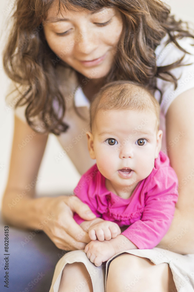 Family Concept: Portrait of Young Mother Taking Care of Her Litt Family Concept: Portrait of Young Mother Taking Care of Her Litt