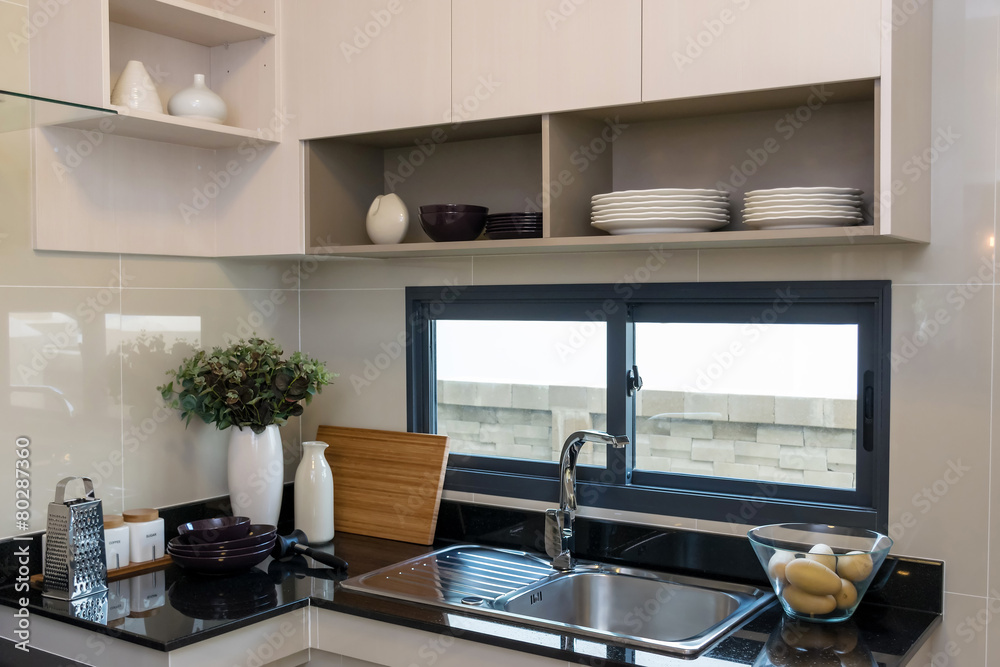 Fototapeta premium Ceramic kitchenware on the marble worktop and shelf