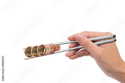 hand holding banknote using chopstick