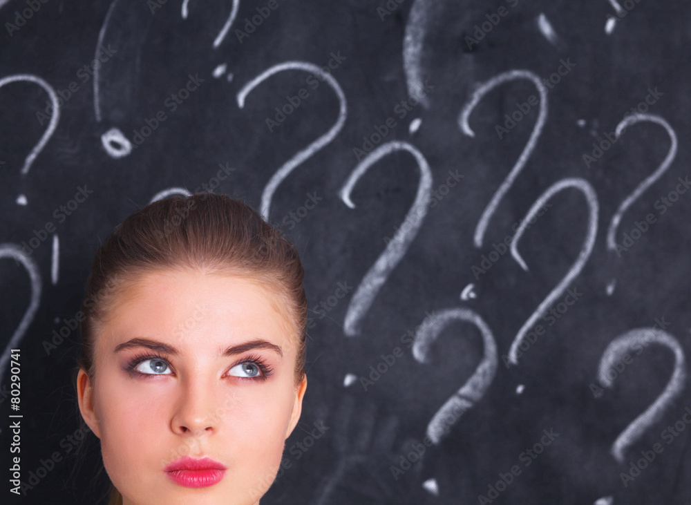 Young girl with question mark on a gray background Young girl with question mark on a gray background