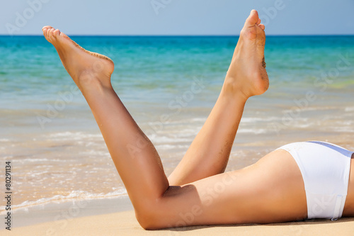 Woman's legs on the beach