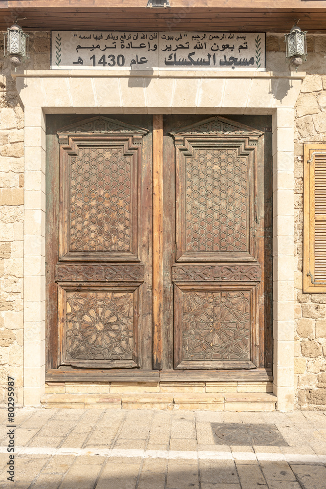 Old wooden door on a background of the facade