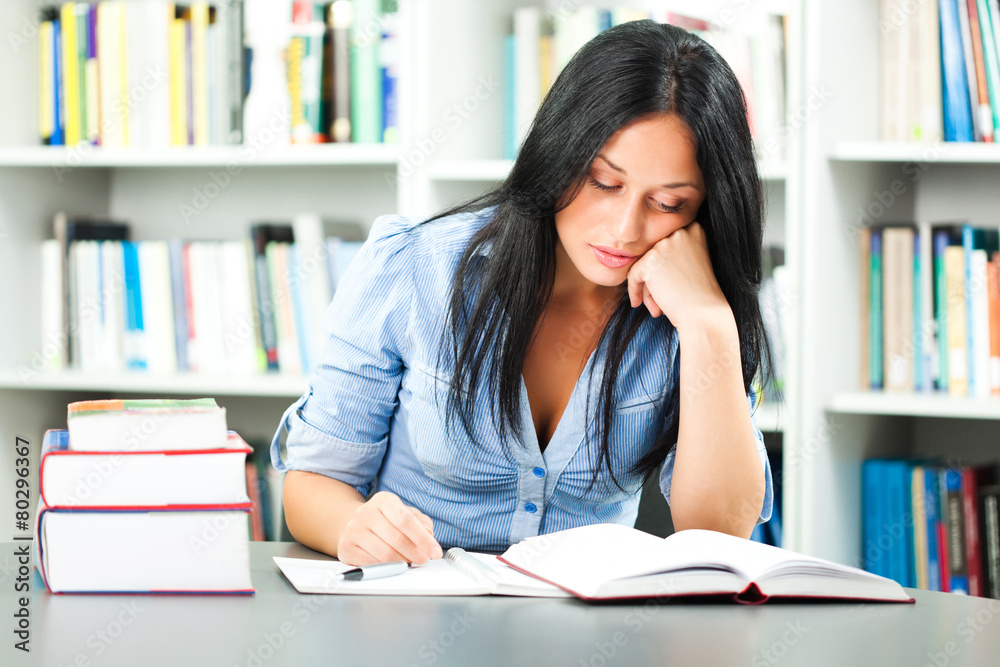 Tired student learning in library Tired student learning in library