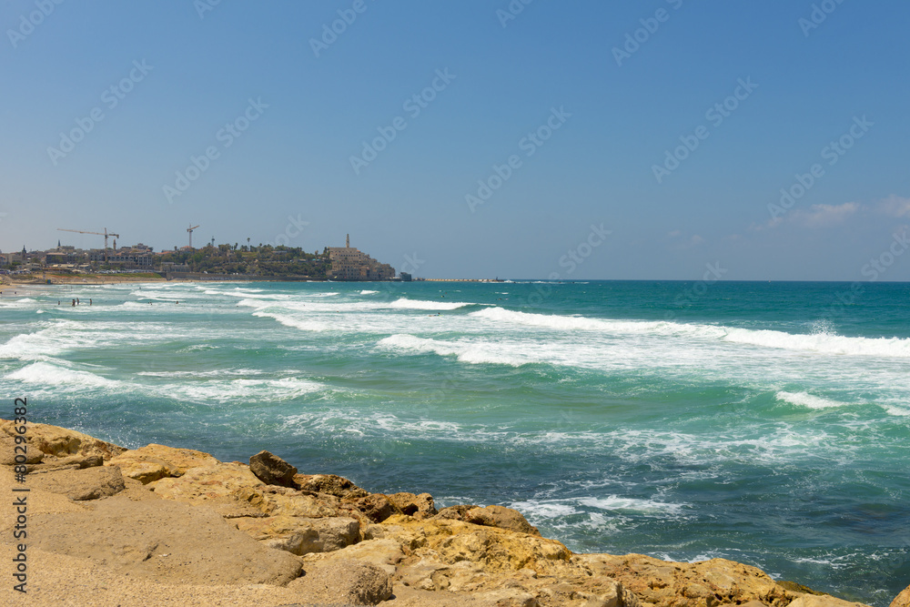 Waves of the Mediterranean sea beating against the stony shore