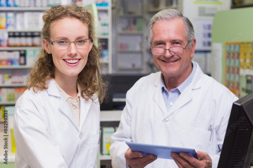 Team of pharmacists smiling at camera Team of pharmacists smiling at camera