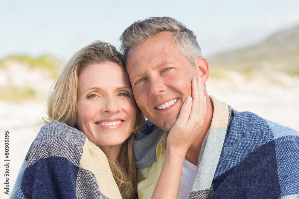 Happy couple wrapped up in blanket Happy couple wrapped up in blanket
