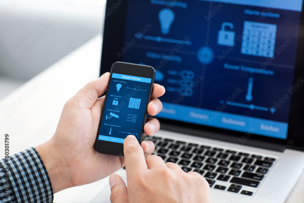 man holding phone with program smart home on the screen man holding phone with program smart home on the screen