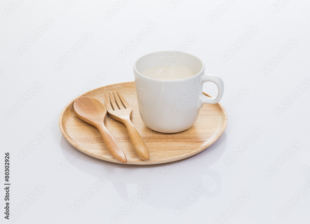 Cup of soy milk with wood plate isolated on white background Cup of soy milk with wood plate isolated on white background