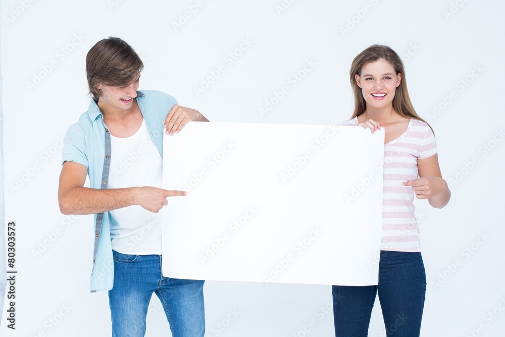 Hipster couple holding poster